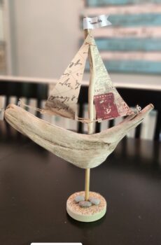 A Unique Sailboat Crafted from Driftwood, Petoskey Stones, Sand, and Map Sails & Traverse City Flag