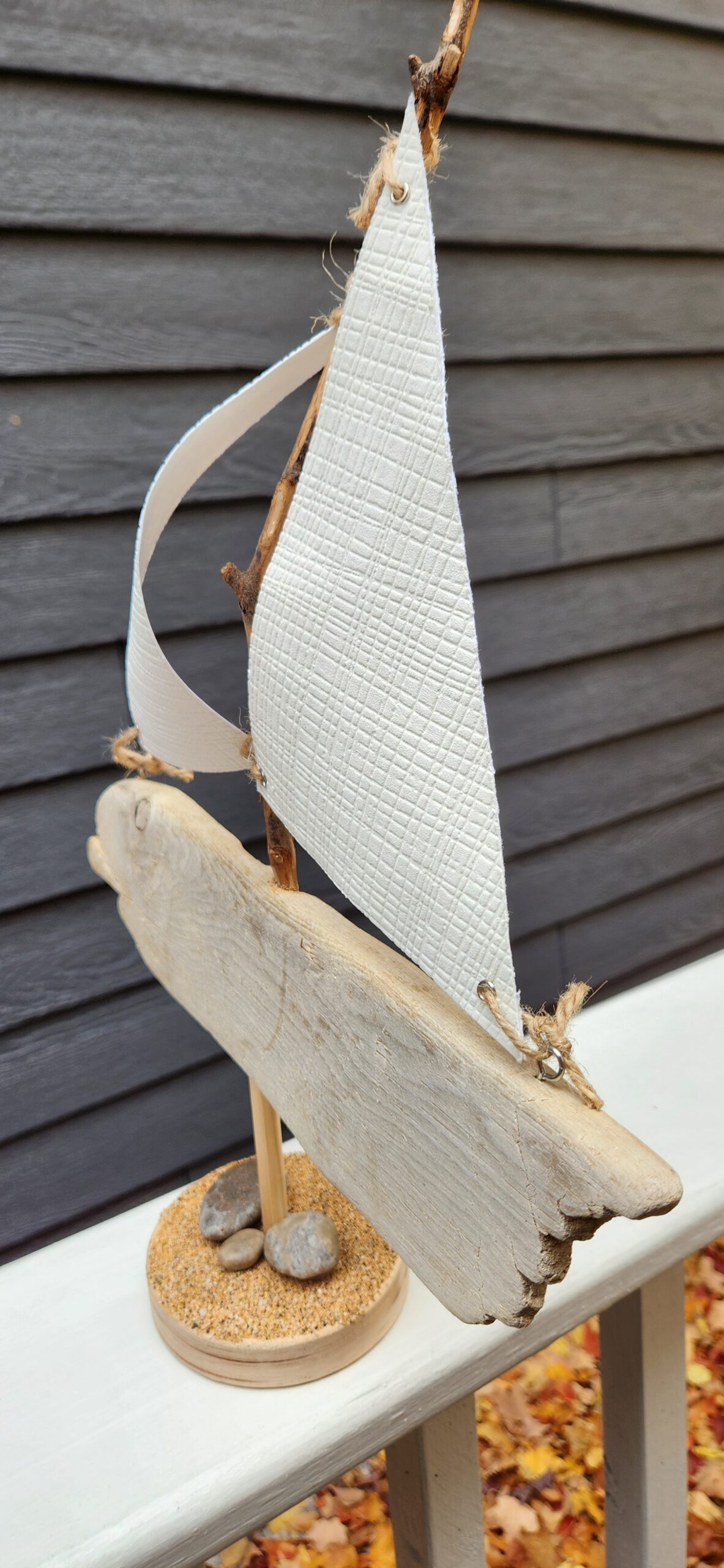 A Unique Sailboat Crafted from Driftwood, Petoskey Stones, Sand, and White Sails - Image 2