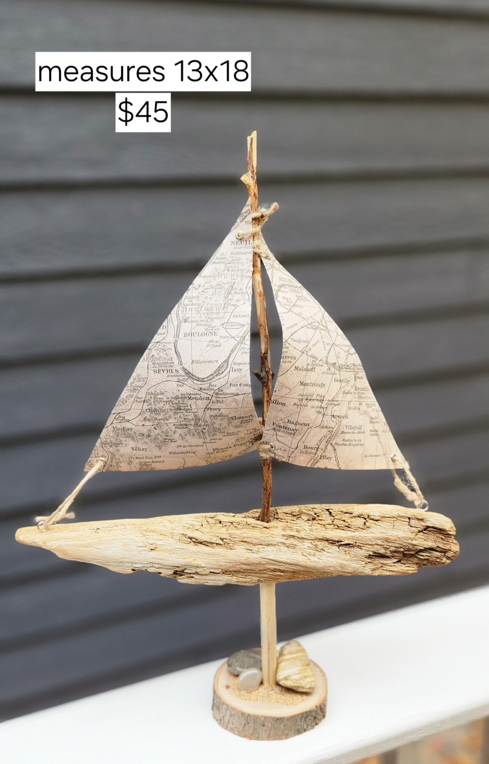 A Unique Sailboat Crafted from Driftwood, Petoskey Stones, Sand, and Map Sails