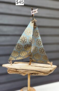 A Unique Sailboat Crafted from Driftwood, Petoskey Stones, Sand, Compose rose Sails and Michigan Flag