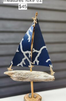 A Unique Sailboat Crafted from Driftwood, Petoskey Stones, Sand, and Navy Sails