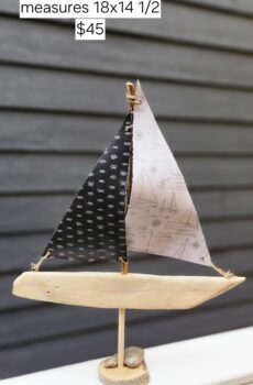 A Unique Sailboat Crafted from Driftwood, Petoskey Stones, Sand, and Black & Gray Sails